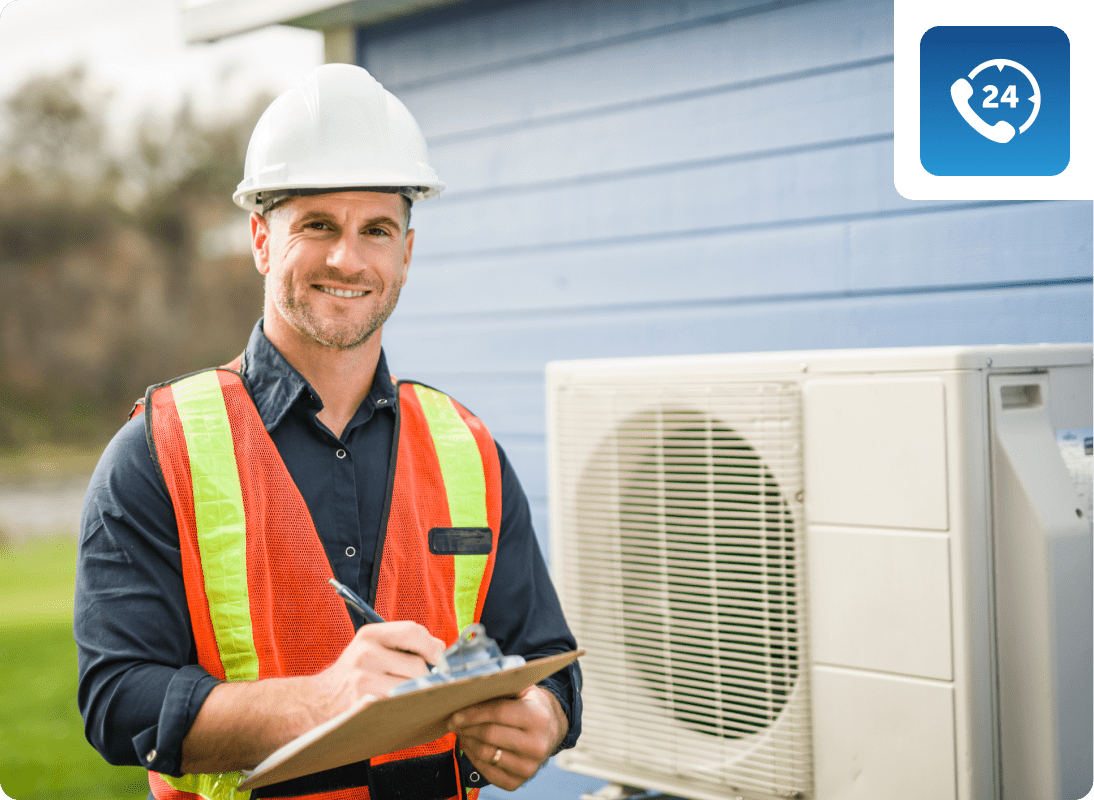 Technician examining outdoor HVAC system